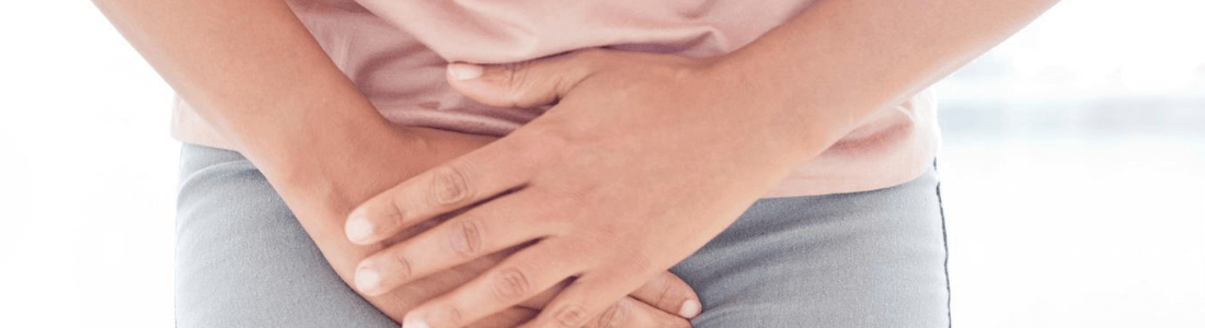 Woman clasping hands over abdomen