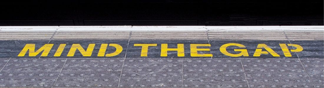 MIND THE GAP written on railway platform edge