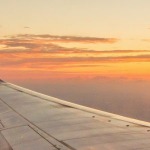 Airplane flying into the sunset representing taking medication abroad