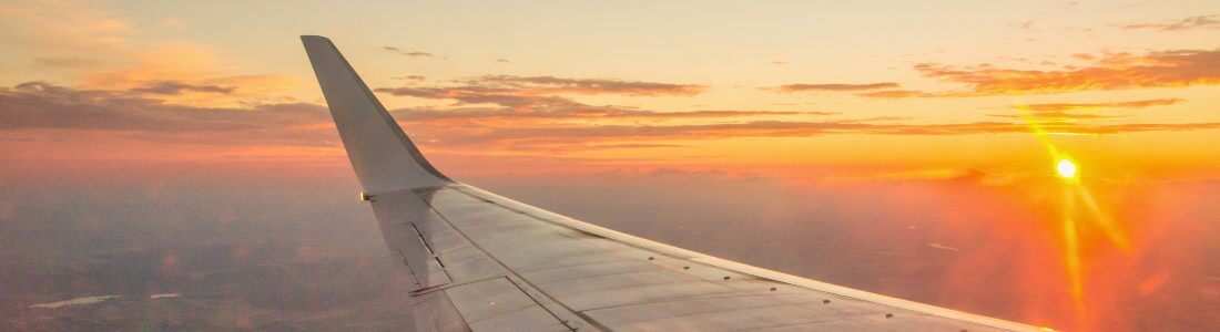 Airplane flying into the sunset representing taking medication abroad